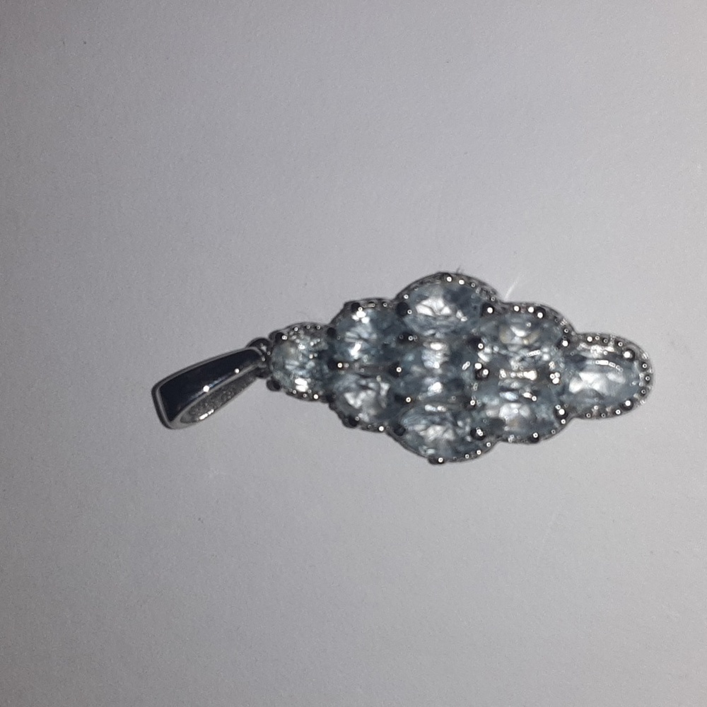 Sky blue topaz pendant in stainless steel.